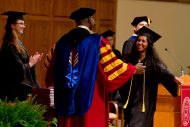 Faith Manickam (Hesston, Kan.) prepares to receive her diploma and a hug from her father, President Joseph A. Manickam.
