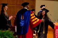 Faith Manickam (Hesston, Kan.) prepares to receive her diploma and a hug from her father, President Joseph A. Manickam.