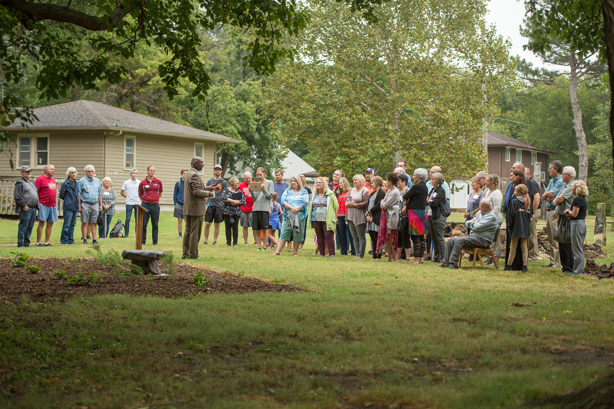 A crowd gathers to remember Mark Short '74 and dedicate a memorial bench.