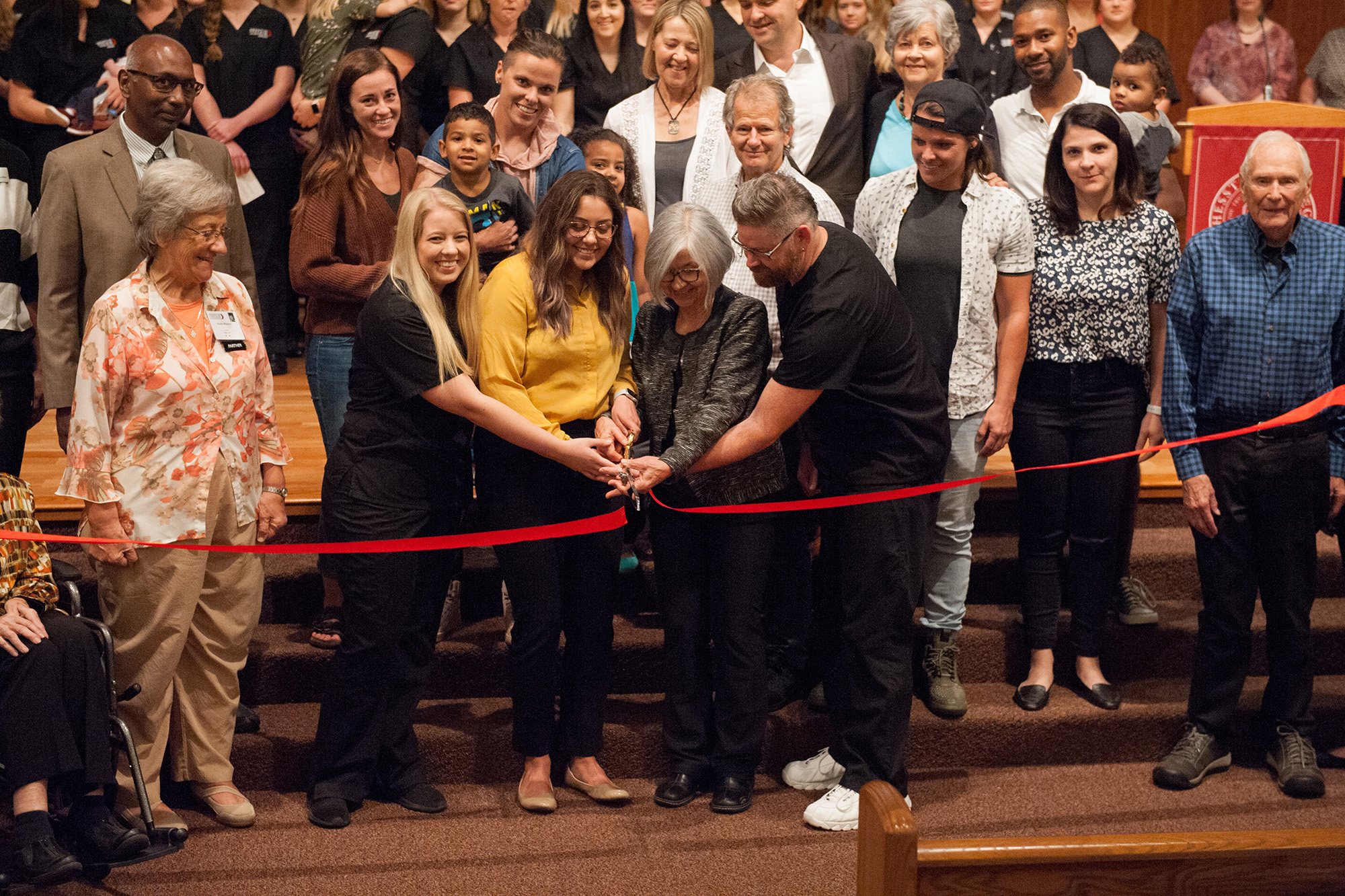 Bonnie Sowers, former director of nursing education, and several current nursing students cut the ribbon at the Bonnie Sowers Nursing Center dedication.