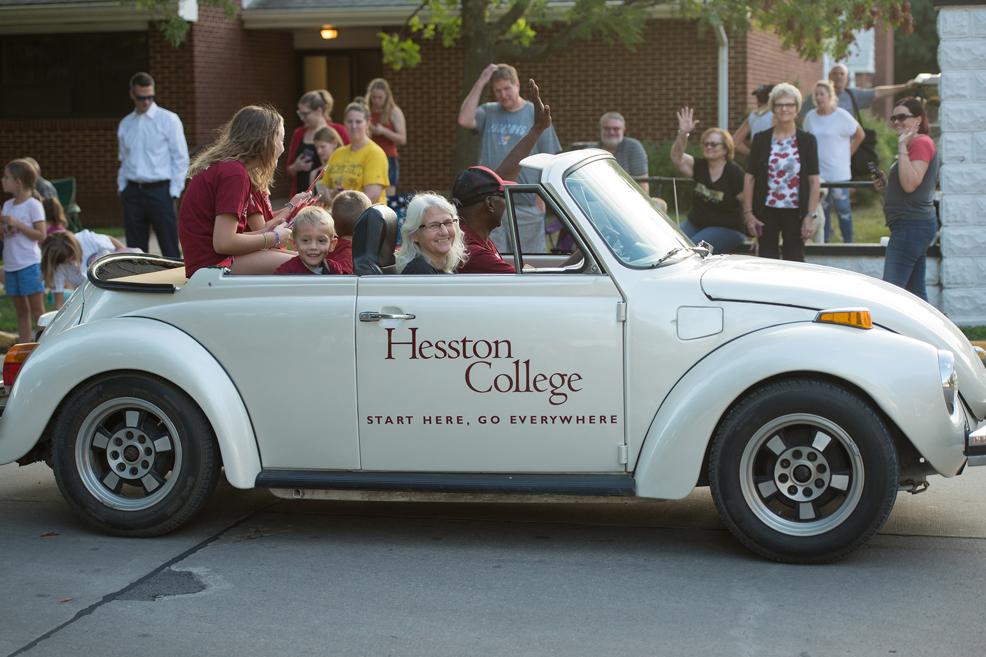 Hesston College President Joe and Wanda Manickam drive the HC bug in the Home Sweet Hesston parade.