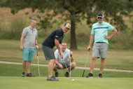 Ryan Roth lines up a putt at the Homecoming Golf Benefit in honor of Floyd Sowers ’71 for his years of volunteer service in organizing and managing the benefit on behalf of the college. Watching in the background are Blake Buhrman ’01, Tyson Miller and Steve Martin ’04, Alumni Association President.