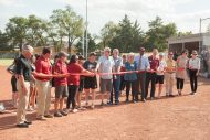 Chelsey Smith ’20 (left center) joins Mick Mullet ’76 and Dave Mullet Ac62, ’64 and others in the ribbon cutting for the new on-campus Bess Mullet Softball Field. The five Mullet brothers have long been Hesston College donors and given to special projects, including the field, which is named in honor of their mother.