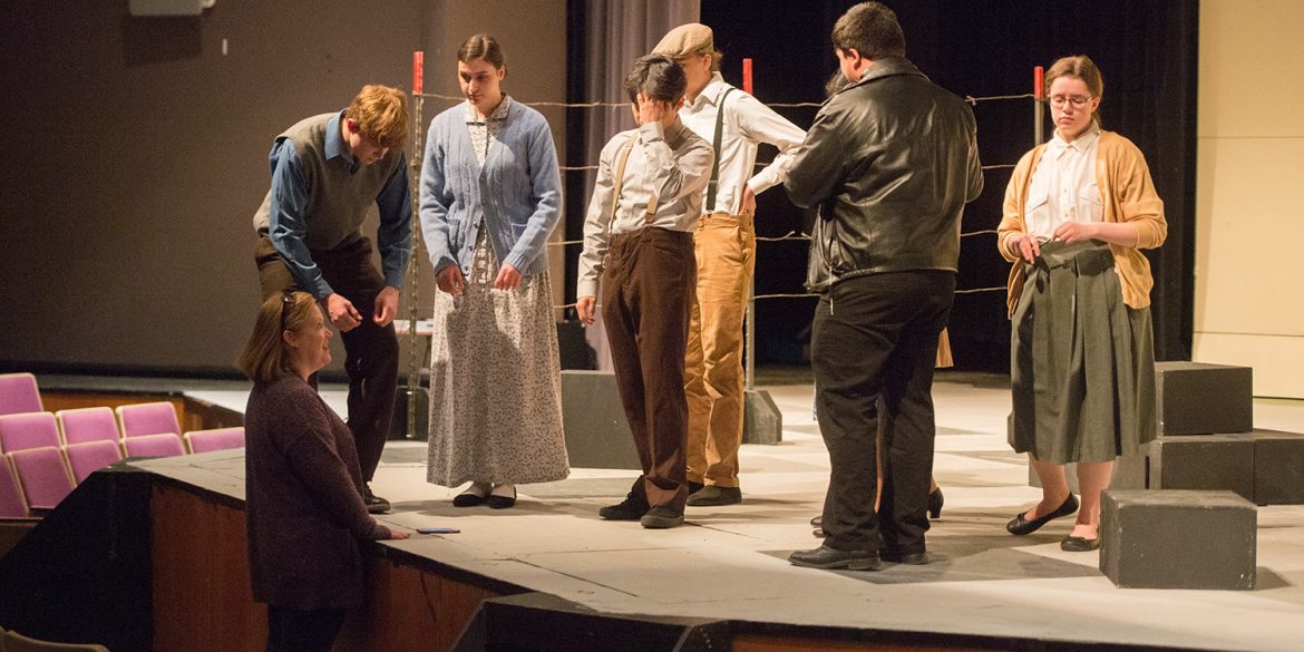 Carla Lahey (left) directs the Touring Theatre Company as they prepare for a performance at Newton High School.