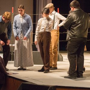 Carla Lahey (left) directs the Touring Theatre Company as they prepare for a performance at Newton High School.