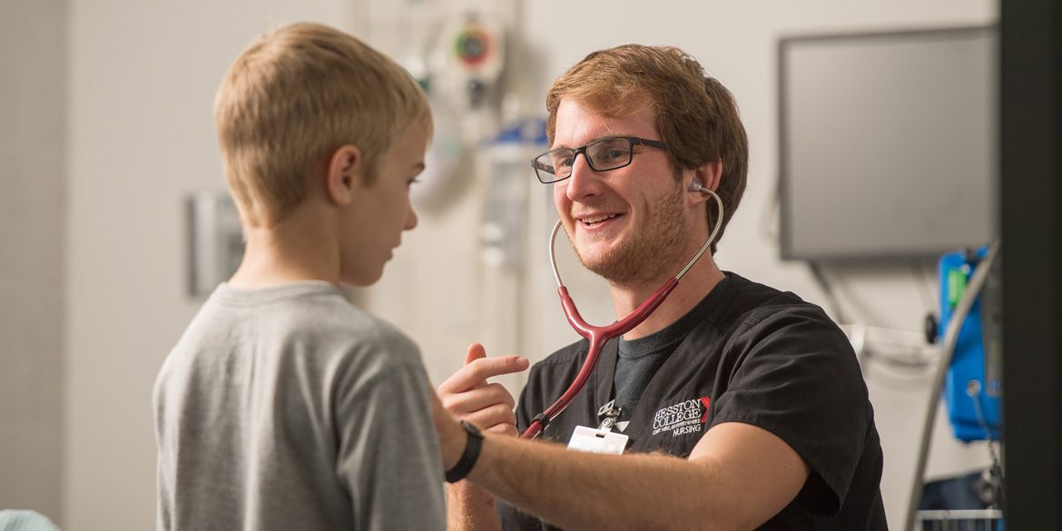 A nursing student works with a patient.