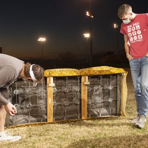 Jacob Mullins and Chris Lichti inspect Goldy's underside, where previous caretakers have written their names.