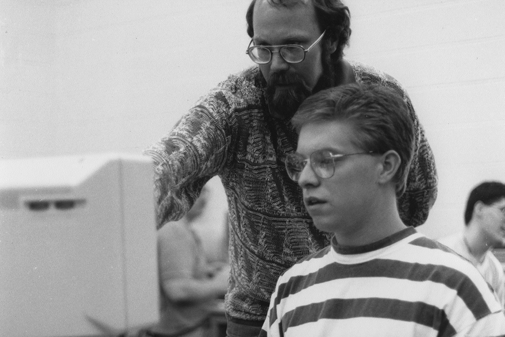 Professor of business and aviation Bob Harder provides guidance to a student.