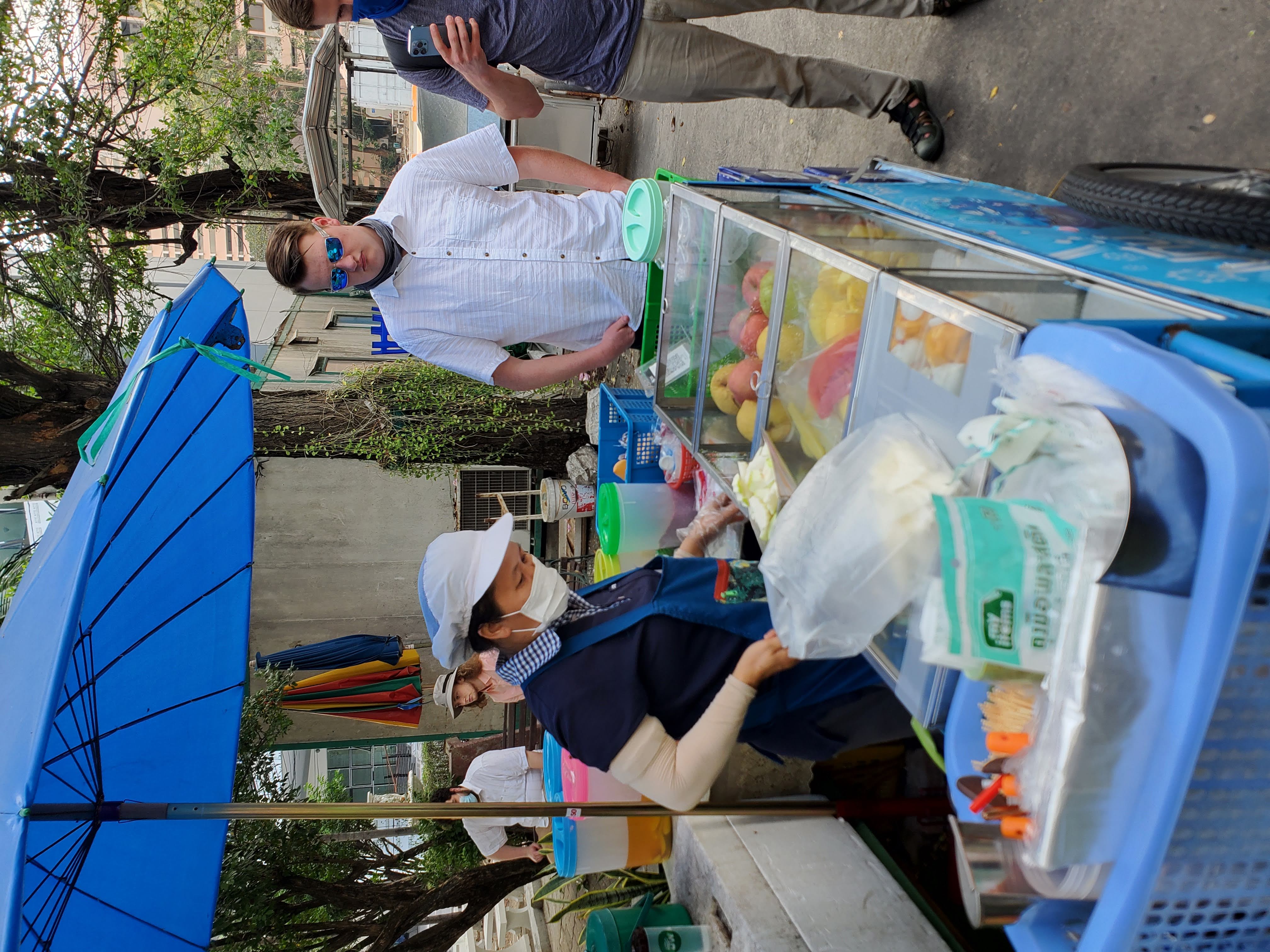 Buying fruit from a street vendor