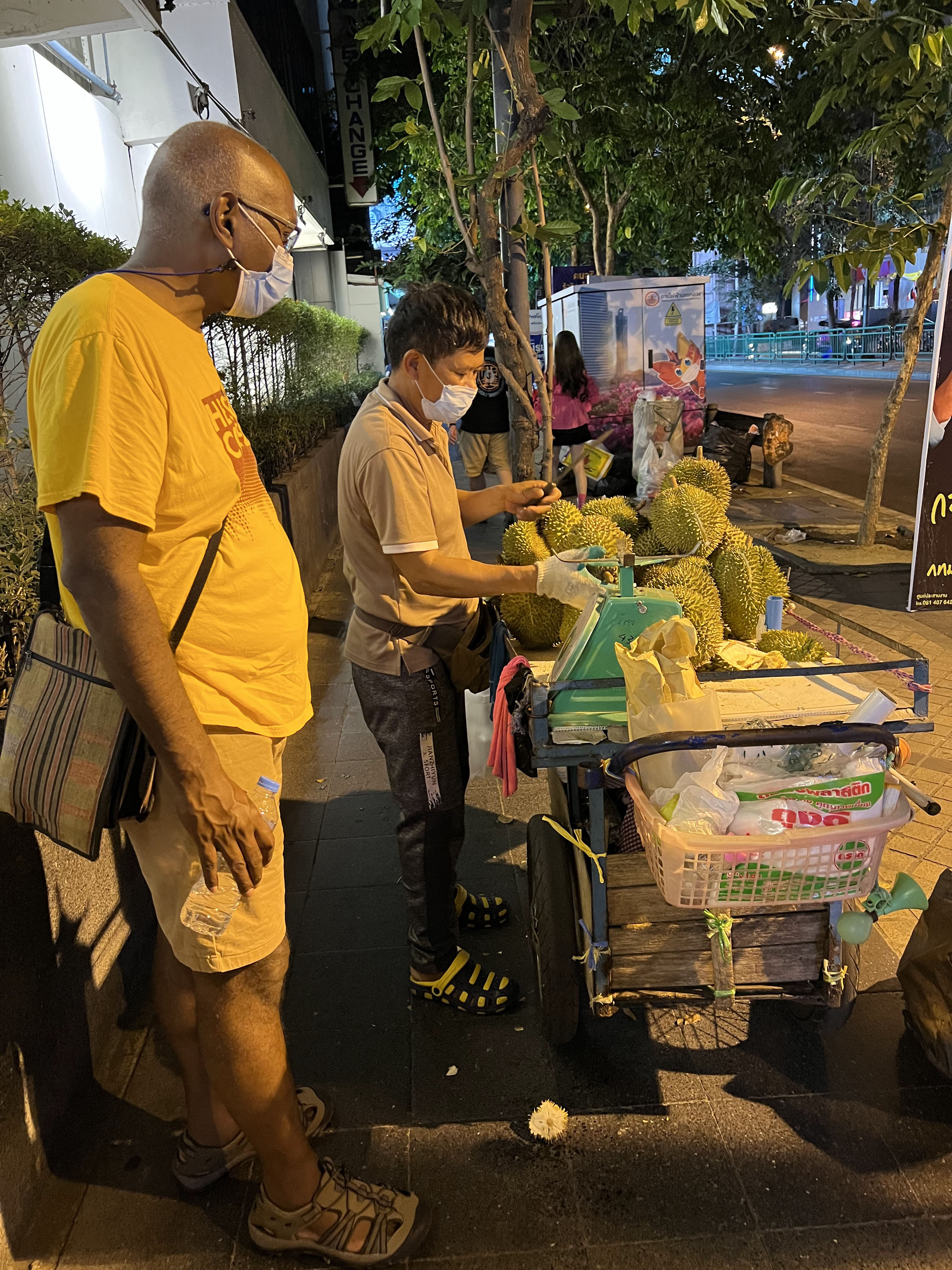 Buying durian fruit from a street vendor