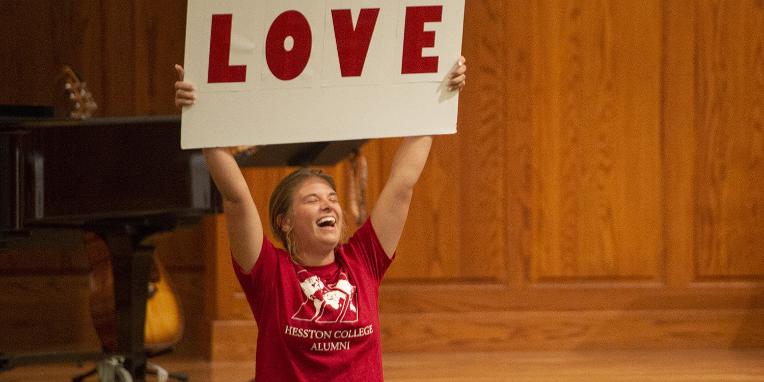 2022 Opening Celebration - student holding sign with "Love"