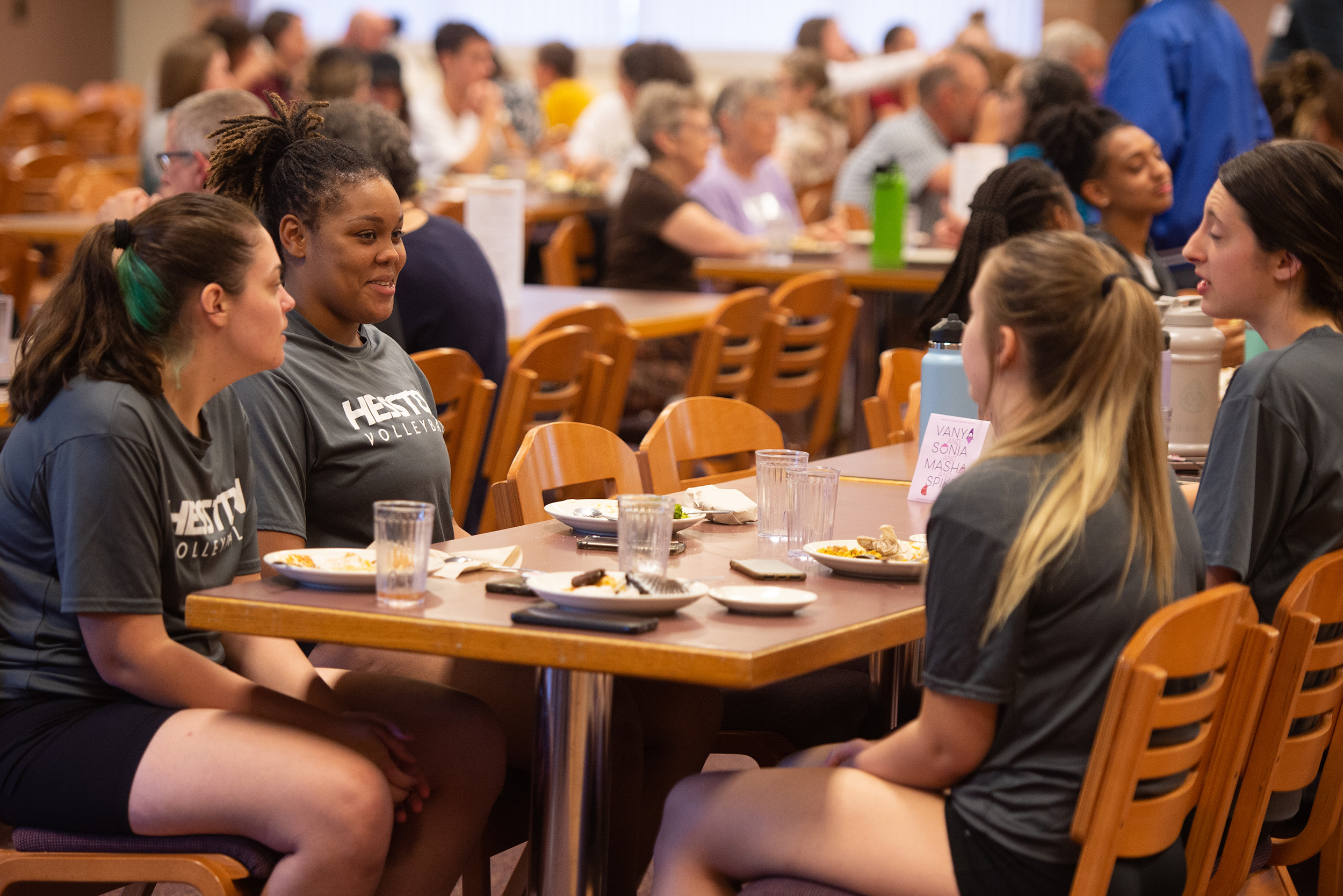 students visit at the international supper at Hesston College Homecoming 2022