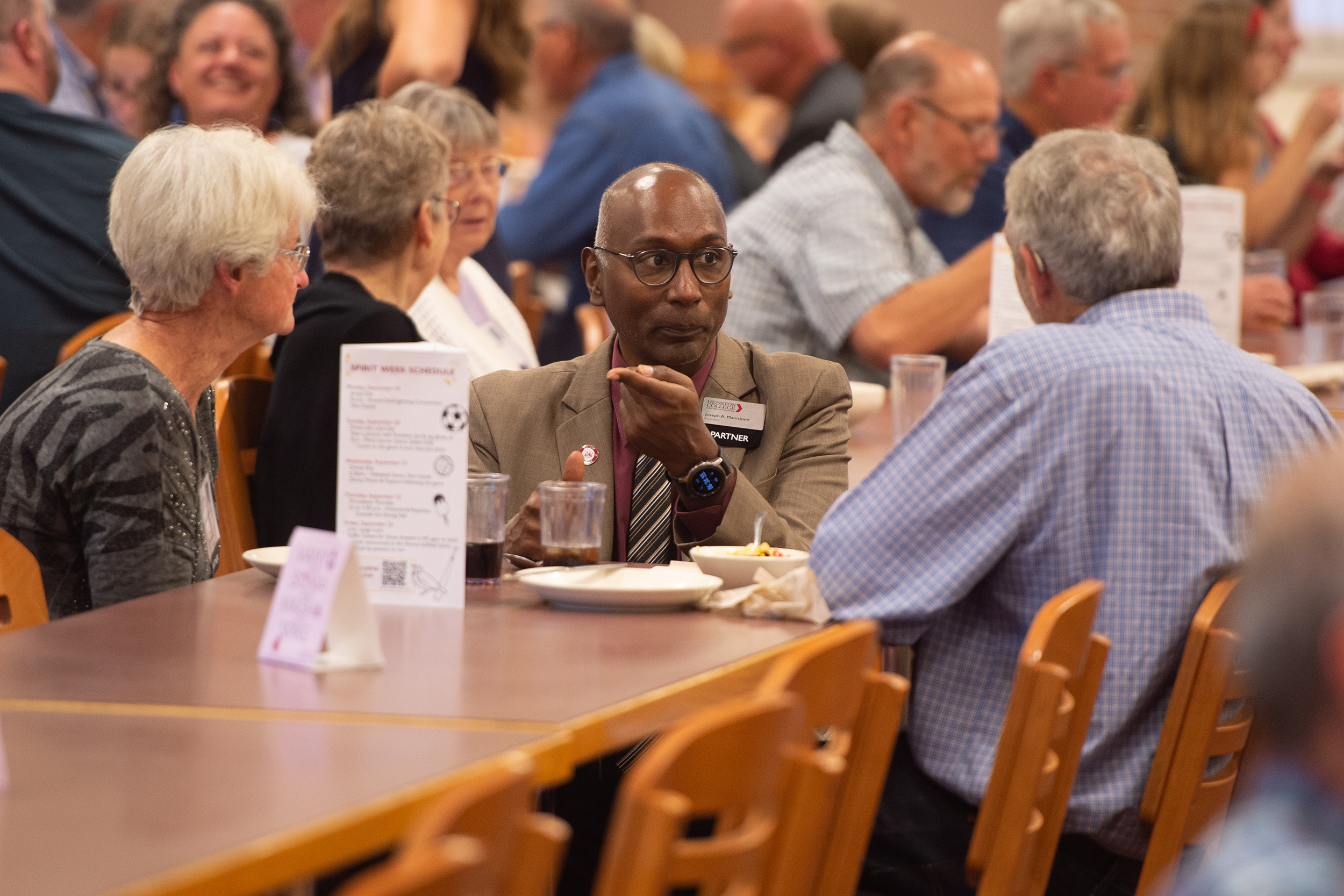 President Manickam visits with alumni at the international supper at Hesston College Homecoming 2022