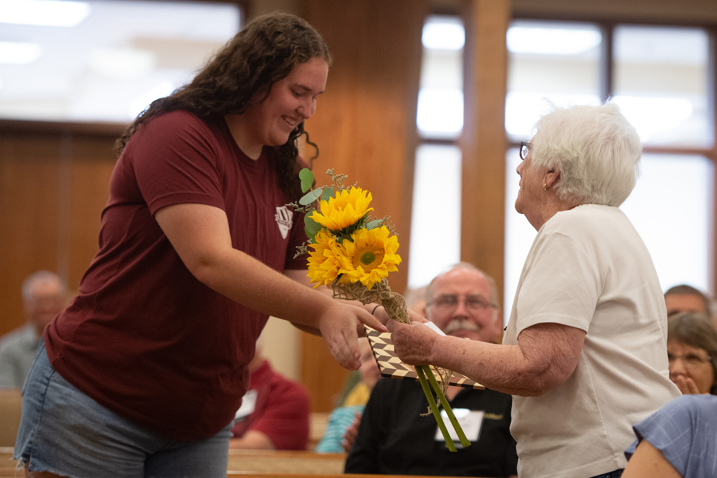 Students presented flowers and special cutting board to charter Partners at the Partner lunch at Hesston College Homecoming 2022