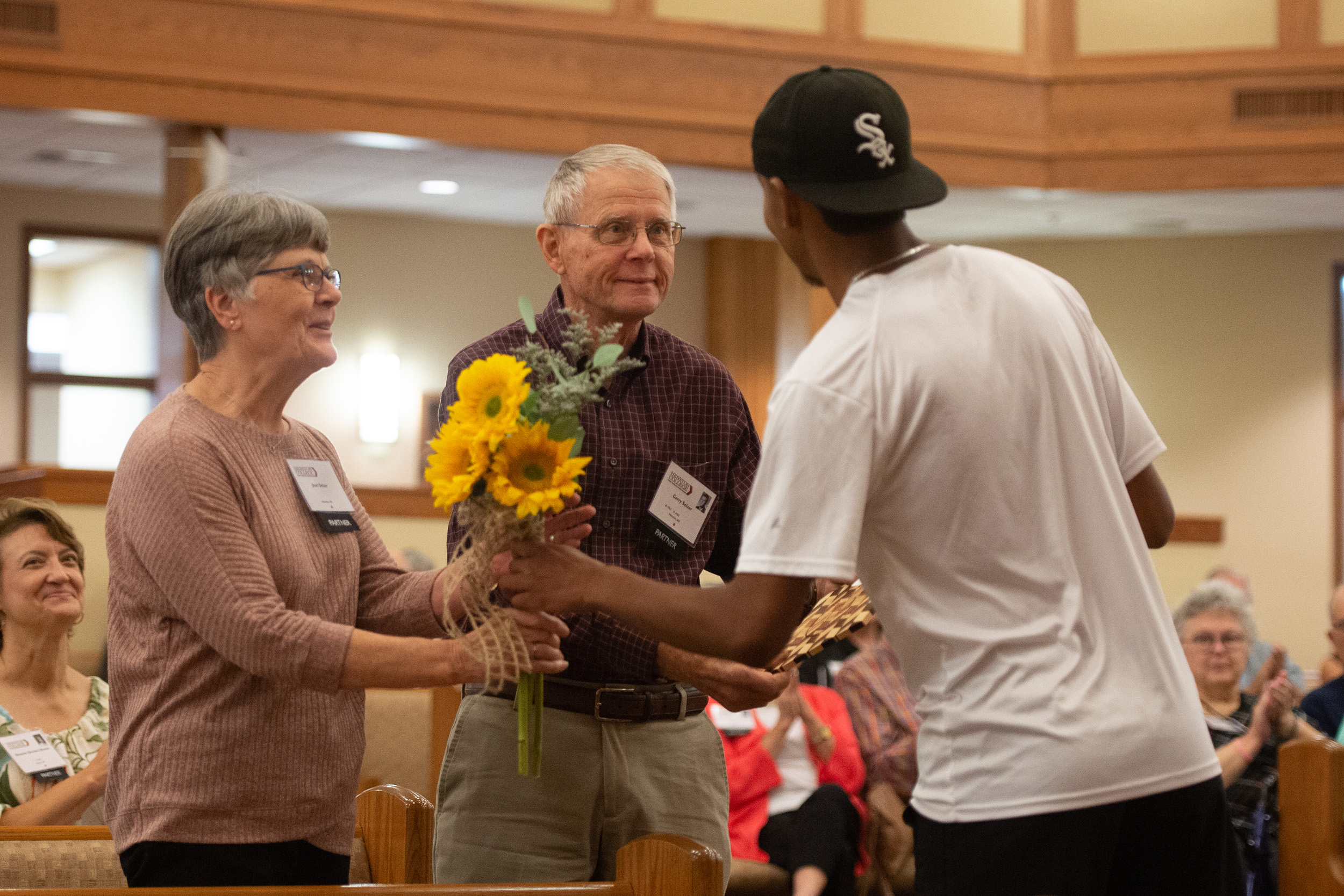 Students presented flowers and special cutting board to charter Partners at the Partner lunch at Hesston College Homecoming 2022