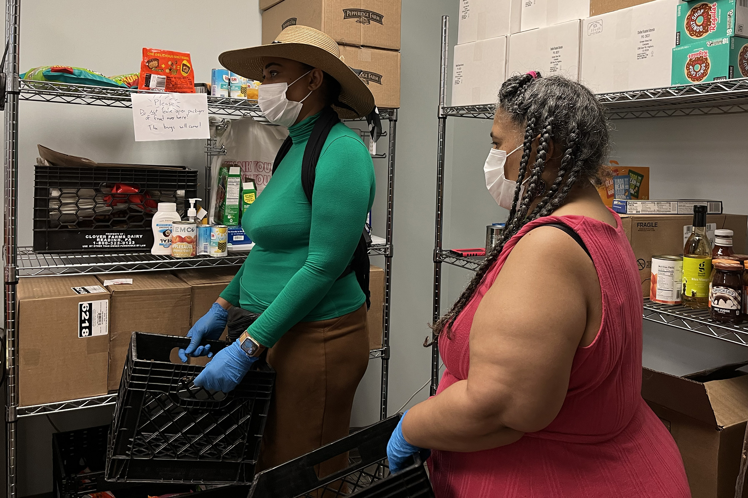 Photo - Wideline Charles and Anita Castle wait to receive their food pantry order.