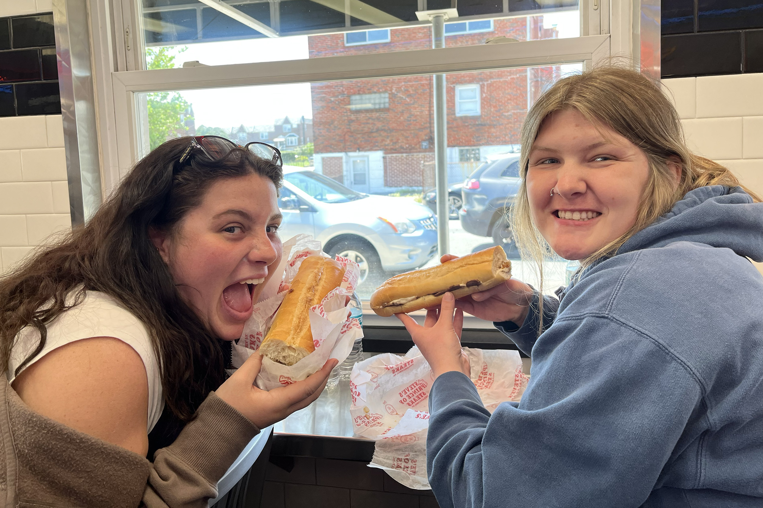 Emily Miller and Kelbe Edwards enjoying cheesesteaks