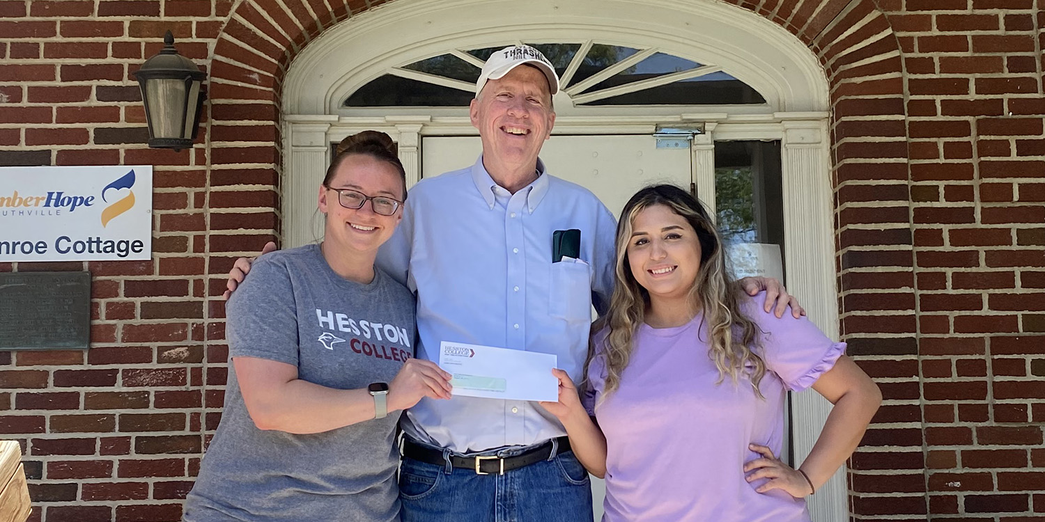 Photo - Hesston College Nursing Club members present a check to Brian Bisbee, executive director of New Hope Shelter.