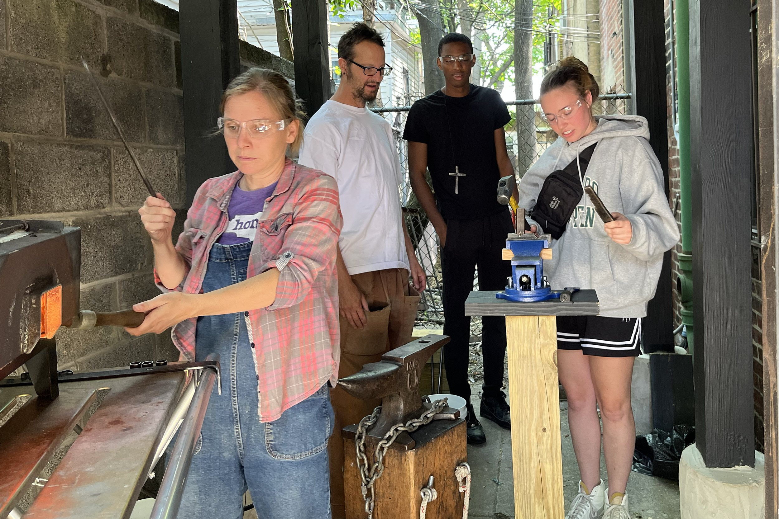 Photo - Making hearts from gun barrels at Raw Tools with Katie Claiborne, Shane Claiborne, Bryce Blake and Smilla Burklin