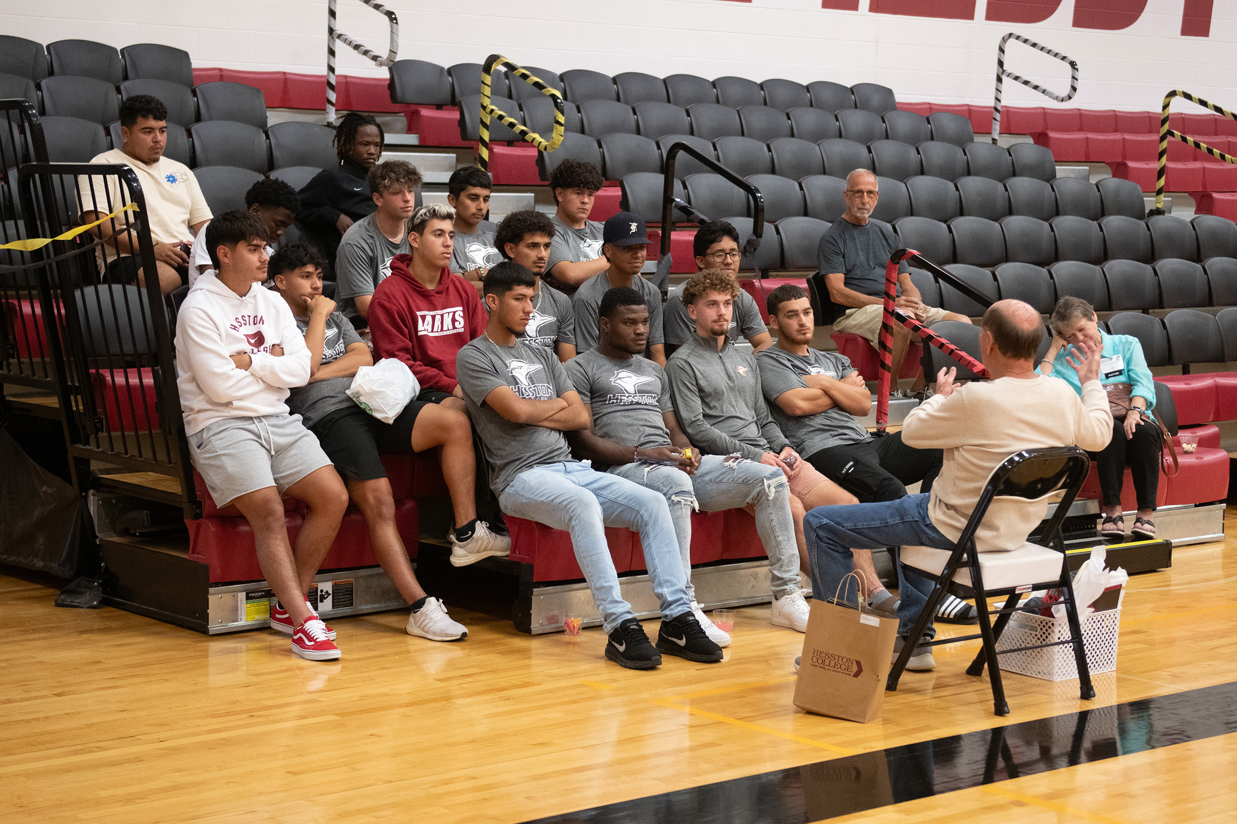 photo - Hesston College Homecoming 2023 - Athletics HoF inductees speak to teams - Gerry Sieber and men's soccer