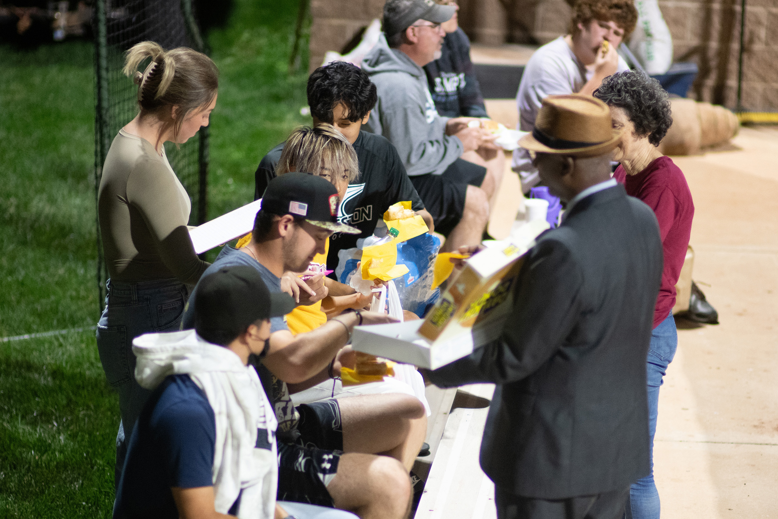 photo - Hesston College Homecoming 2023 - President Manickam hands out donuts at the Reverse Druber's Run