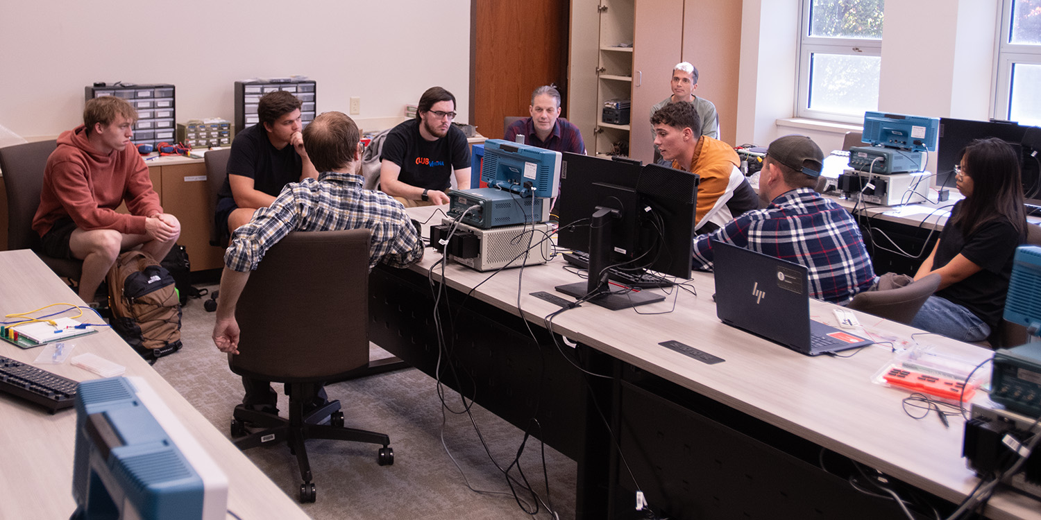 photo - Hesston College and Eastern Mennonite University engineering students review a collaborative project in the electrical engineering lab at Hesston College.