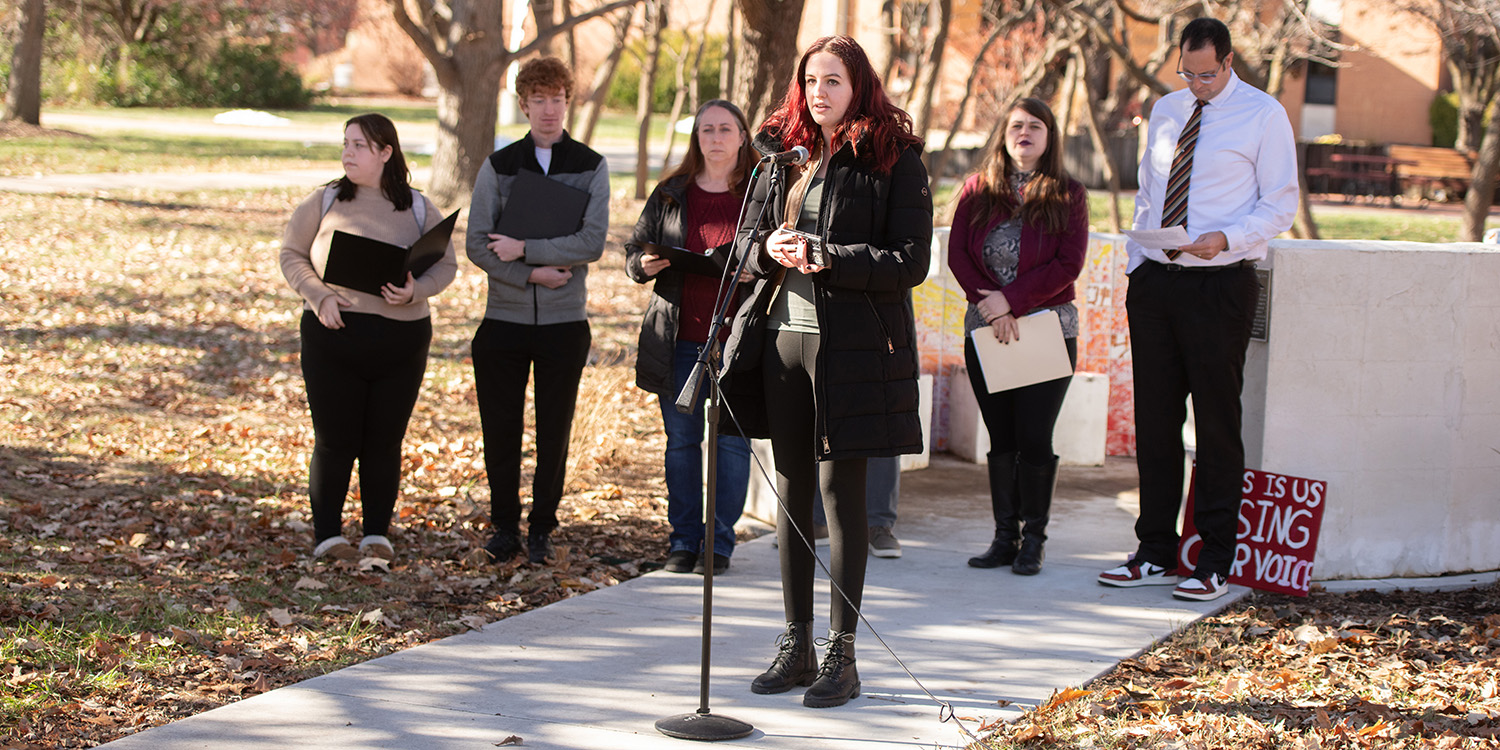 photo - Meg Beyer, senior and member of the Title IX Implementation Group addresses campus at the Healing Circle dedication.