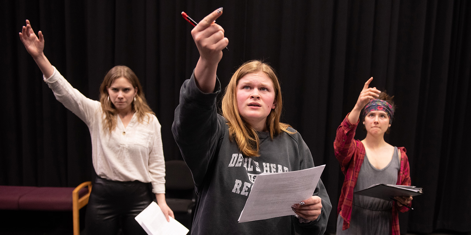 Hadassa Friesen, Caroline Miller and Rylee Weishaupt rehearse “Death by a Thousand Papercuts” for Pen to Paper to Performance.