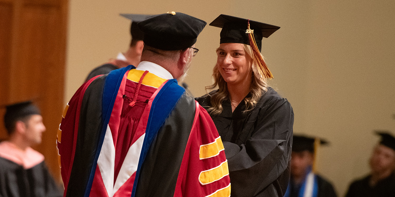 Photo - Heaven Trapp of Lufkin, Texas, receives her diploma from Interim President Ross Peterson-Veatch.