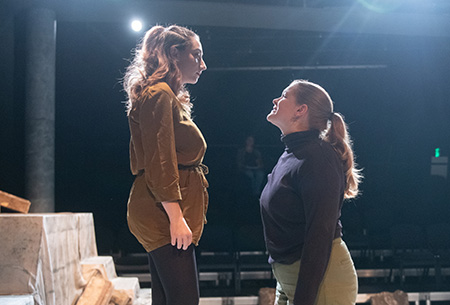 Actors Chloe Robinson and Caroline Miller perform a scene from the fall production of “Antigone.”