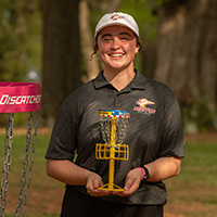 Josalyn holding her All-American trophy from the disc golf national tournament